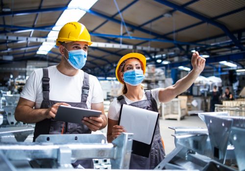 factory-workers-with-face-masks-protected-against-corona-virus-doing-quality-control-of-production-in-factory
