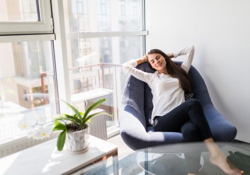 relaxing-woman-sitting-comfortable-sofa-lounge-chair-home